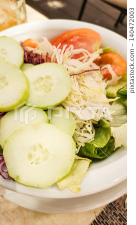 Fresh summer salad with cucumber, tomatoes, and cabbage enjoyed during vacation in croatia Fresh summer salad with cucumber, tomatoes, and cabbage enjoyed during vacation in croatia 140472003