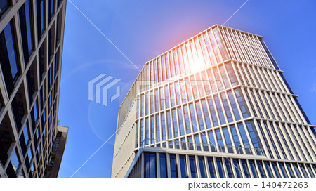 View of an modern apartment building standing next to a new modern office building with a glass facade. View of an modern apartment building standing next to a new modern office building with a glass facade. 140472263