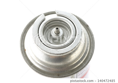 A photograph of a cassette gas canister against a white background. A photograph of a cassette gas canister against a white background. 140472485