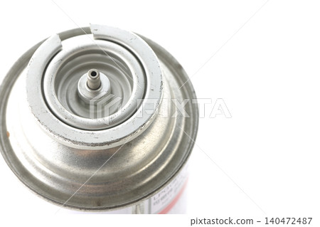 A photograph of a cassette gas canister against a white background. A photograph of a cassette gas canister against a white background. 140472487