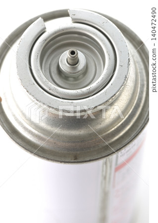 A photograph of a cassette gas canister against a white background. A photograph of a cassette gas canister against a white background. 140472490