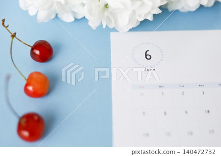 Cherries, hydrangeas, and a June calendar (blue background) 140472732