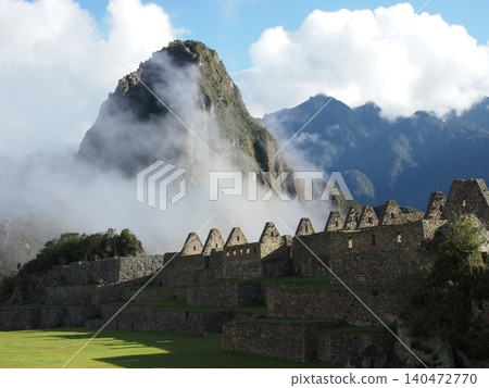 The stone architecture of Machu Picchu ruins and Mount Huayna Picchu (Peru) shrouded in mist. The stone architecture of Machu Picchu ruins and Mount Huayna Picchu (Peru) shrouded in mist. 140472770