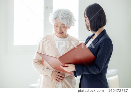 Senior woman talking to a salesman Senior woman talking to a salesman 140472787