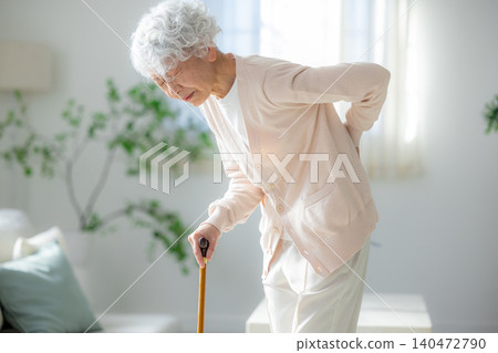 Senior woman with low back pain Senior woman with low back pain 140472790