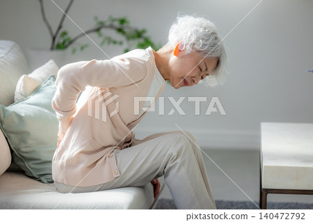 Senior woman suffering from back pain Senior woman suffering from back pain 140472792