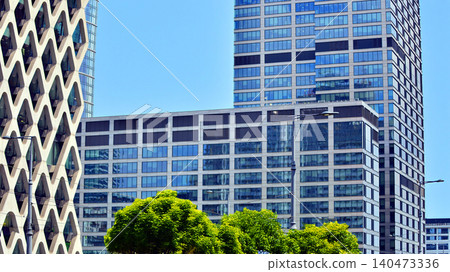 Exterior view of corporate headquarters glass buildings architecture. Modern sustainable glass office buildings. Glass windows in energy-efficient buildings. Financial business center buildings. Exterior view of corporate headquarters glass buildings architecture. Modern sustainable glass office buildings. Glass windows in energy-efficient buildings. Financial business center buildings. 140473336