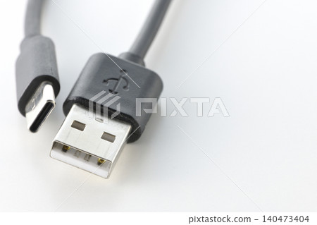 A photo of a USB Type-A and Type-C cable against a white background. A photo of a USB Type-A and Type-C cable against a white background. 140473404
