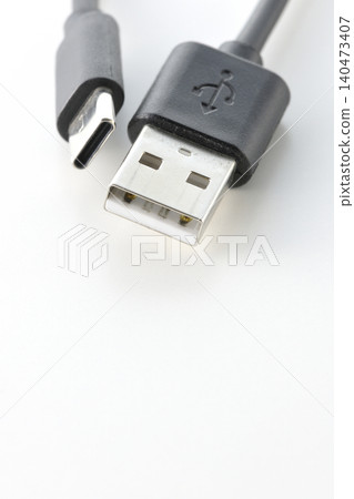 A photo of a USB Type-A and Type-C cable against a white background. A photo of a USB Type-A and Type-C cable against a white background. 140473407