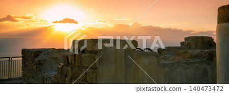 Beautiful sunrise over Masada fortress. The ruins of the palace of King Herod, Masada. Sunrise morning sky in Dead Sea region. Israel. Beautiful sunrise over Masada fortress. The ruins of the palace of King Herod, Masada. Sunrise morning sky in Dead Sea region. Israel. 140473472