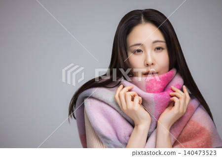 A woman wearing a muffler A woman wearing a muffler 140473523