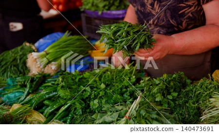 Person holding fresh herbs at market produce selection Person holding fresh herbs at market produce selection 140473691