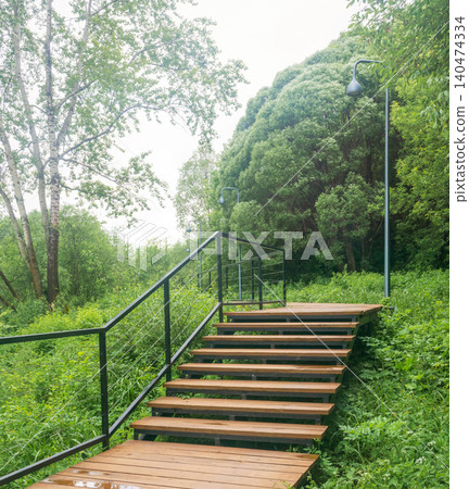 Wooden stairs on the educational trail in the nature park. 140474334