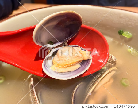A seafood soup packed with clams. A close-up of the clams. A seafood soup packed with clams. A close-up of the clams. 140474580