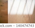 A background image of a wood-grain table with bright light streaming in. 140474743