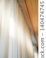 A window that lets in natural light and vertical blinds 140474745