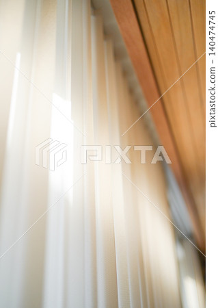 A window that lets in natural light and vertical blinds A window that lets in natural light and vertical blinds 140474745