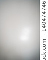 A white wall with a textured surface, illuminated by soft light. 140474746