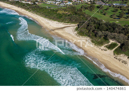 Aerial scene capturing One Mile Beach near Forster, NSW, Australia, with a small creek flowing across the sand before entering the Pacific Ocean. Aerial scene capturing One Mile Beach near Forster, NSW, Australia, with a small creek flowing across the sand before entering the Pacific Ocean. 140474861