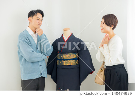 A woman struggling to decide which kimono to buy 140474959