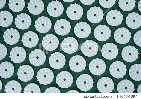 Macro abstract background of green acupuncture massage mat needles. Macro abstract background of green acupuncture massage mat needles. 140474994