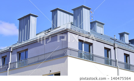 Modern residential structure showcasing a contemporary design with sloped roof, big windows and balconies. Modern residential structure showcasing a contemporary design with sloped roof, big windows and balconies. 140475564