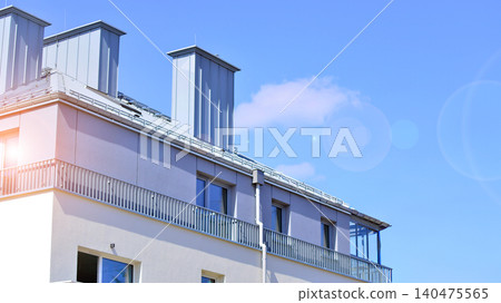 Modern residential structure showcasing a contemporary design with sloped roof, big windows and balconies. Modern residential structure showcasing a contemporary design with sloped roof, big windows and balconies. 140475565