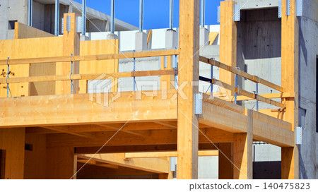 Laminate wood floors and supports of a mass timber multi story green, sustainable office building construction project. The building structure also has concrete walls. Laminate wood floors and supports of a mass timber multi story green, sustainable office building construction project. The building structure also has concrete walls. 140475823