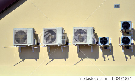 Air conditioners on the wall of a commercial building. Air conditioners on the wall of a commercial building. 140475854