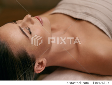 Woman, lying and calm in spa for wellness or peace, massage therapy or skincare and relax to free tension. Female person, resort and luxury for stress relief or rest for wellbeing with mindfulness. Woman, lying and calm in spa for wellness or peace, massage therapy or skincare and relax to free tension. Female person, resort and luxury for stress relief or rest for wellbeing with mindfulness. 140476103