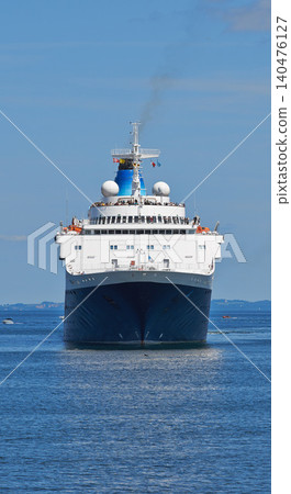 Ship, water and sailing at sea to travel with smoke, windows and transportation for vacation journey. Vessel, blue sky and ocean with yacht for tourism, holiday and adventure with skyline and nature Ship, water and sailing at sea to travel with smoke, windows and transportation for vacation journey. Vessel, blue sky and ocean with yacht for tourism, holiday and adventure with skyline and nature 140476127