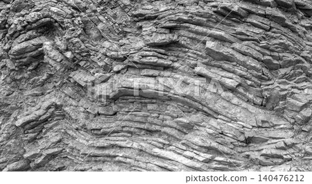 Close-up of weathered sedimentary rock showing distinct layers. Black and white Close-up of weathered sedimentary rock showing distinct layers. Black and white 140476212