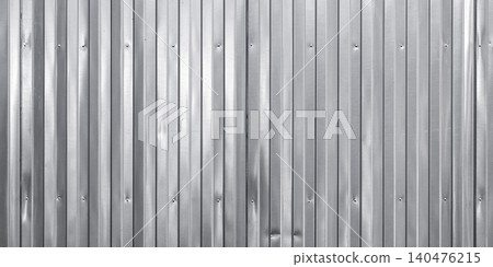 A textured shiny metal wall with vertical corrugated patterns. Black and white 140476215