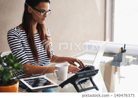 Woman, desk and computer with blueprints for interior design or creative career, happy and working on graphics on laptop. Online, search and plan project with digital technology and information 140476375