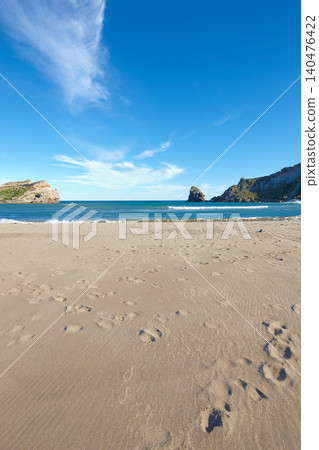 Beach sand, blue sky and ocean, landscape with nature and environment, coastline and travel destination. Horizon, waves and seascape with natural background, tropical location or island for holiday Beach sand, blue sky and ocean, landscape with nature and environment, coastline and travel destination. Horizon, waves and seascape with natural background, tropical location or island for holiday 140476422