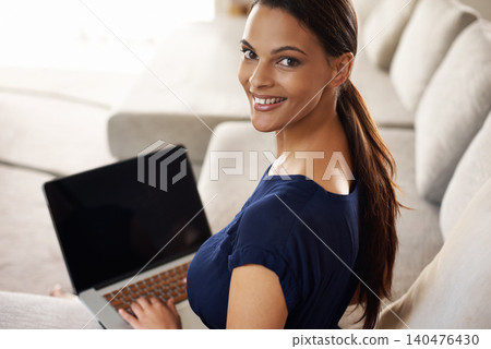 Businesswoman, laptop and work from home, portrait or technology on sofa in lounge. Smile, dedication and living room for journalist or blogger, entrepreneur or happy female with online startup 140476430