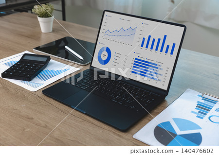 Spreadsheet data and business dashboard displayed on a laptop with charts, reports and calculator, supporting data analysis, performance monitoring, reporting workflow and business management. 140476602