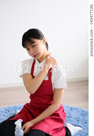 Housekeeping service provider suffering from shoulder pain 140477186