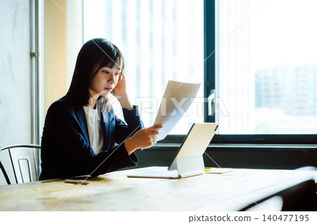A businesswoman reading documents A businesswoman reading documents 140477195