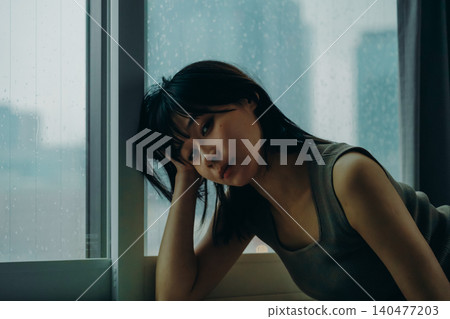 A woman looking at me from the window A woman looking at me from the window 140477203