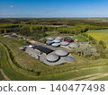 Aerial shot of a modern biogas plant surrounded by green forests and rapeseed fields near Hammel, Denmark 140477498