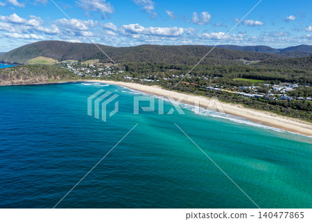 Aerial scene capturing Boomerang Beach near Pacific Palms, NSW, Australia, with residential homes and native bushland visible in the background.  140477865