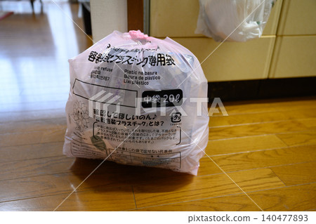 Plastic waste bags placed near the kitchen Plastic waste bags placed near the kitchen 140477893