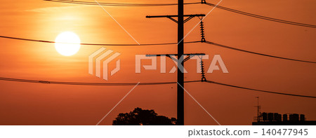 High voltage electric transmission pylon. High voltage power lines against sunset sky. Electricity pylon and electric power transmission lines. High Voltage pole provide power supply. Energy crisis. High voltage electric transmission pylon. High voltage power lines against sunset sky. Electricity pylon and electric power transmission lines. High Voltage pole provide power supply. Energy crisis. 140477945