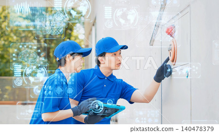 Workers inspecting machines with digital technology Workers inspecting machines with digital technology 140478379