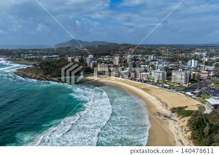Aerial view of Forster Main Beach and the ocean baths with the township of Forster in the background on the Mid North Coast of NSW Australia. Turquoise coastal waters, sandy shoreline and seaside 140478611