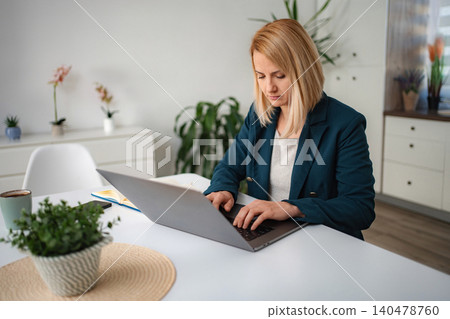 Businesswoman working remotely from home office typing on laptop 140478760