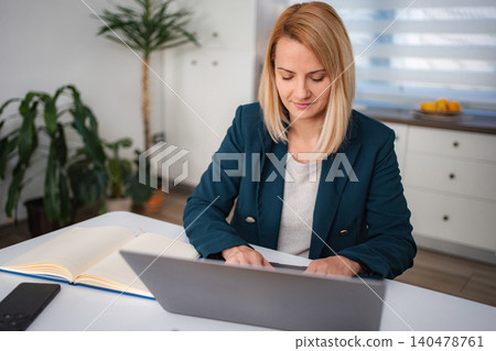 Woman working from home using laptop computer 140478761