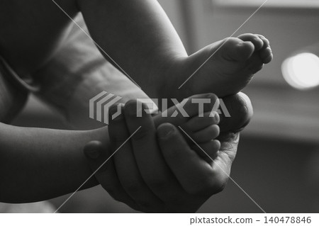 Close-Up of Baby Feet in Gentle Hands Close-Up of Baby Feet in Gentle Hands 140478846