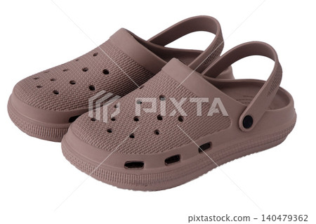 Pair of dusty rose rubber clogs isolated on white background Pair of dusty rose rubber clogs isolated on white background 140479362